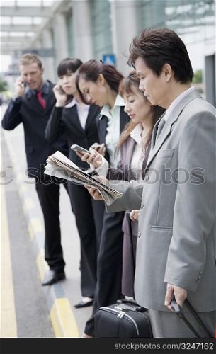 Business executives waiting for taxi at an airport