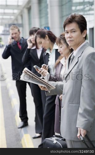 Business executives waiting for taxi at an airport