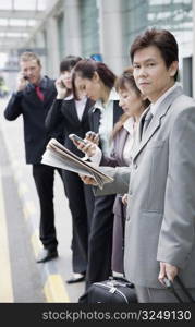 Business executives waiting for taxi at an airport