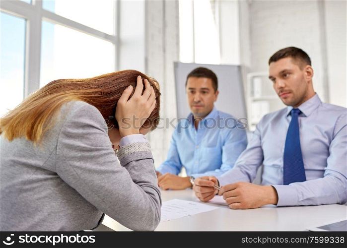 business, failure and people concept - desperate woman on job interview at office. desperate woman on job interview at office