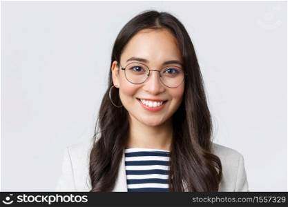 Business, finance and employment, female successful entrepreneurs concept. Close-up of smiling asian beautiful businesswoman wearing glasses and suit, looking confident and happy.. Business, finance and employment, female successful entrepreneurs concept. Close-up of smiling asian beautiful businesswoman wearing glasses and suit, looking confident and happy