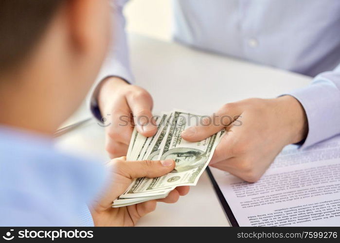 business, finance deal and people concept - close up of hands with us dollar money and contract. close up of hands with dollar money and contract