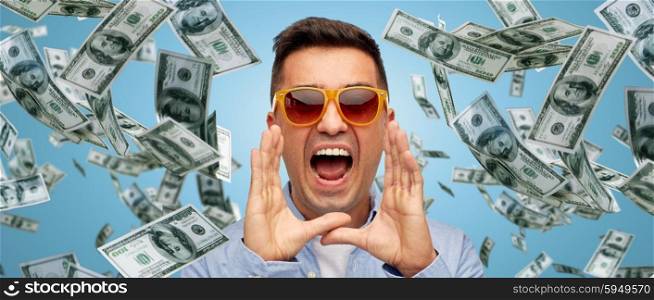 business, finance, emotions, and people concept - face of angry middle aged latin man in shirt and sunglasses shouting over blue background with heap of falling dollar money