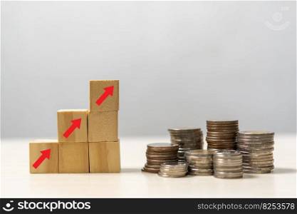 Business finance investments economy stack coin inflation and arrow red with wood cube on desk.