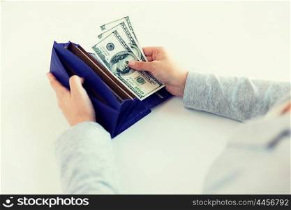 business, finance, saving, banking and people concept - close up of woman hands with wallet and us dollar money
