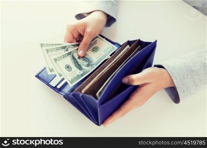 business, finance, saving, banking and people concept - close up of woman hands with wallet and us dollar money