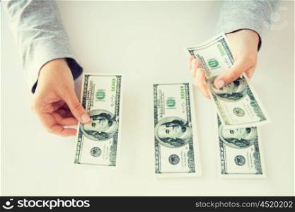 business, finance, saving, banking and people concept - close up of woman hands counting us dollar money