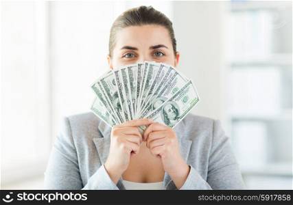 business, finance, saving, banking and people concept - close up of woman hiding her face behind us dollar money fan