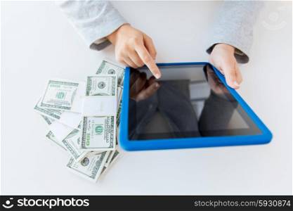 business, finance, saving, technology and people concept - close up of woman hands with tablet pc computer and us dollar money