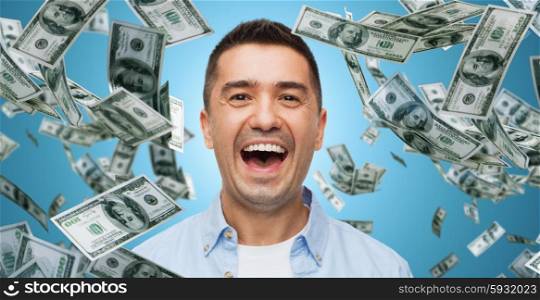 business, finance, success, emotions and people concept - laughing man over blue background with heap of falling dollar money