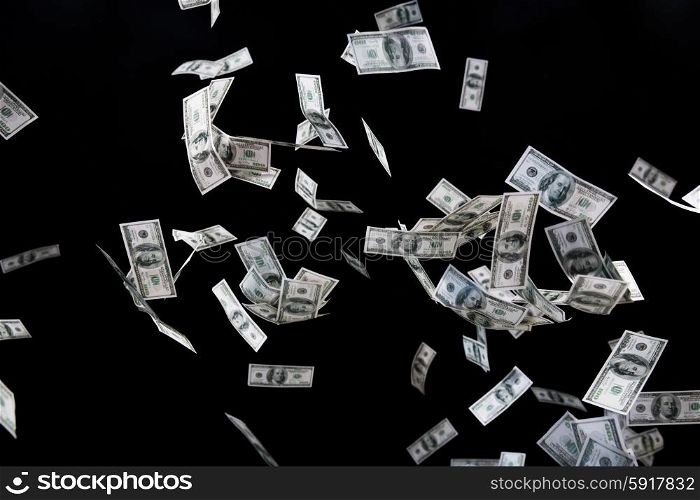 business, finance, waste and concept - close up of us dollar money flying over black background