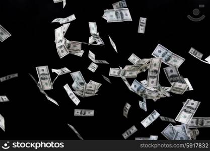 business, finance, waste and concept - close up of us dollar money flying over black background