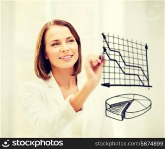 business, finances and economics - businesswoman drawing charts in the air