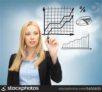 business, finances and economics - businesswoman drawing graphs in the air