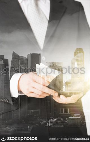business, finances and people concept - close up of businessman with euro money in wallet over city with double exposure. close up of businessman with euro money in wallet