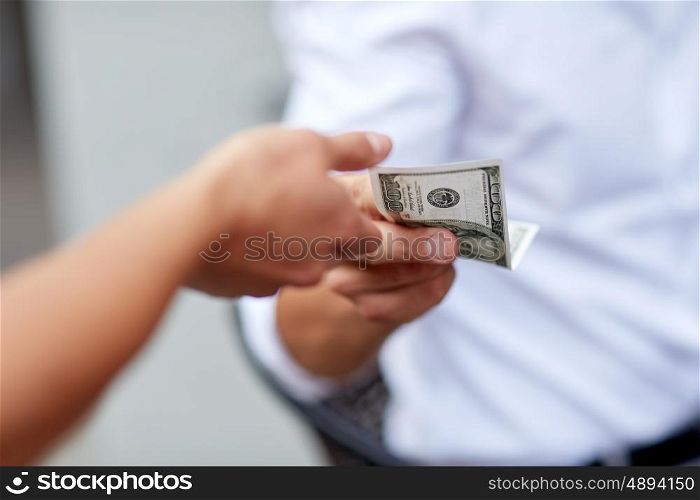 business, finances, payment, charity and people concept - close up of hands giving and receiving dollar money