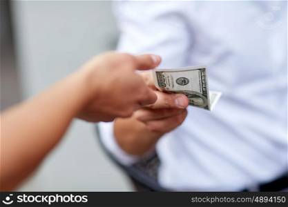 business, finances, payment, charity and people concept - close up of hands giving and receiving dollar money