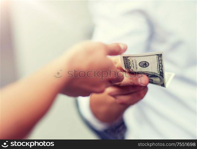 business, finances, payment, charity and people concept - close up of hands giving and receiving dollar money. close up of hands giving and receiving dollar money