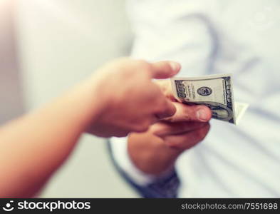 business, finances, payment, charity and people concept - close up of hands giving and receiving dollar money. close up of hands giving and receiving dollar money