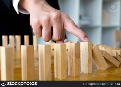 Business finger stops domino continuous overturned meaning that hindered business failure. Stop over this business failure concept.