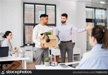 business, firing and job loss concept - executive seeing off sad fired male office worker holding box of his personal stuff. executive seeing off sad fired male office worker