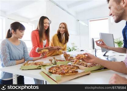 business, food, lunch and people concept - happy international business team eating pizza in office