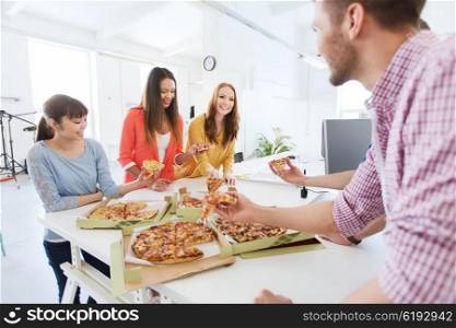 business, food, lunch and people concept - happy international business team eating pizza in office
