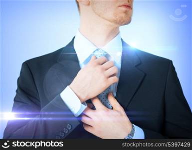 business, formal clothes and dating - man adjusting his tie