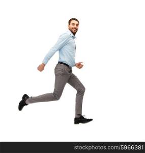 business, freedom, movement and people concept - smiling young man jumping or running away