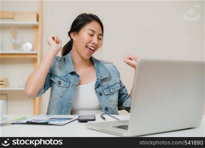 Business freelance woman stretching her body because feel tired after working on laptop, smart female working at home. Lifestyle women relax after working at home concept.
