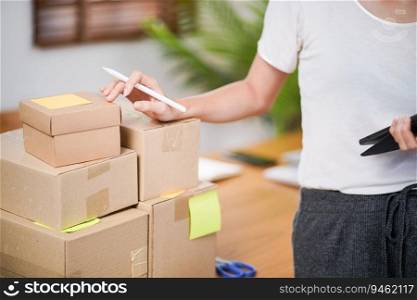 Business From Home Asian woman preparing package delivery box Shipping for shopping online. young start up small business owner at home online order.