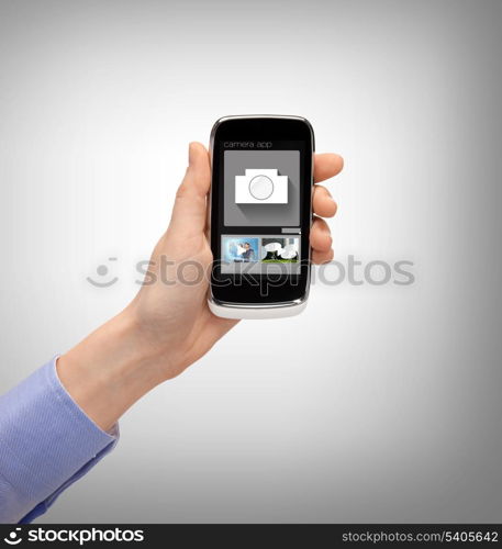 business, future technology and internet - hand with smartphone showing instant picture application