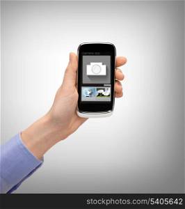business, future technology and internet - hand with smartphone showing instant picture application