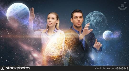 business, future technology and people concept - businessman and businesswoman with planet and hologram over space background. businessman and businesswoman over space