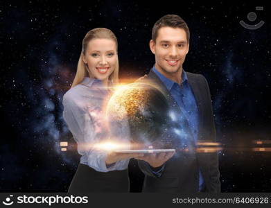 business, future technology and people concept - businessman and businesswoman with tablet pc computer and planets hologram over space background. businesspeople with tablet pc and planets in space