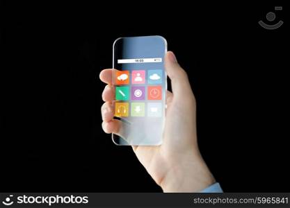 business, future technology and people concept - close up of male hand holding and showing transparent smartphone with icon set on screen over black background