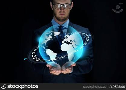 business, future technology, mass media, cyberspace and people - businessman with virtual earth projection over black background. businessman with virtual earth projection