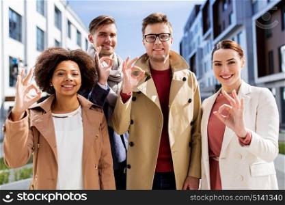business, gesture and corporate concept - international group of people showing ok hand sign outdoors. international business team showing ok hand sign