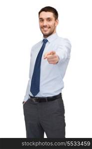 business, gesture and office concept - handsome buisnessman pointing finger at you
