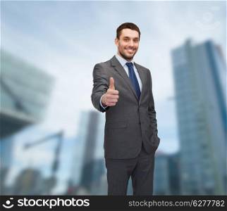 business, gesture and office concept - handsome buisnessman showing thumbs up
