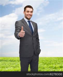 business, gesture and office concept - handsome buisnessman showing thumbs up