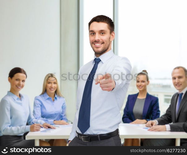 business, gesture and office concept - handsome businessman pointing finger at you