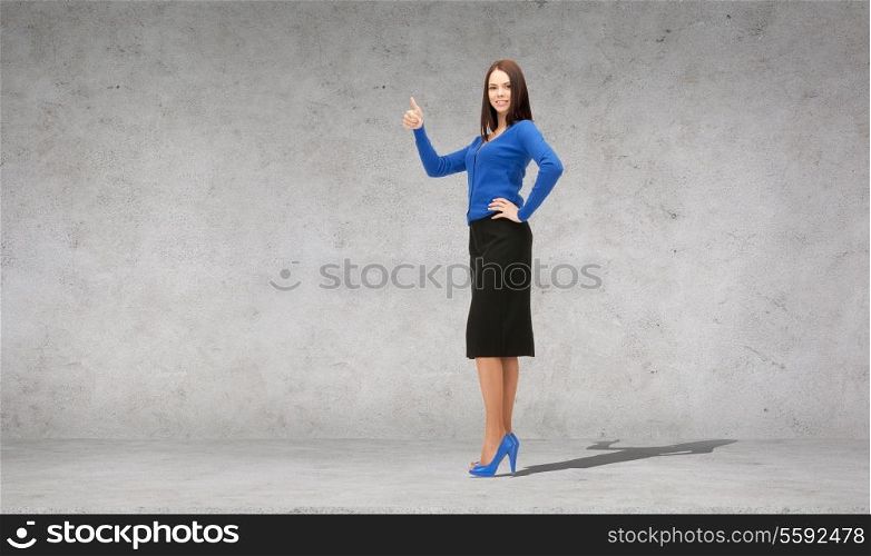 business, gesture and office concept - smiling businesswoman showing thumbs up