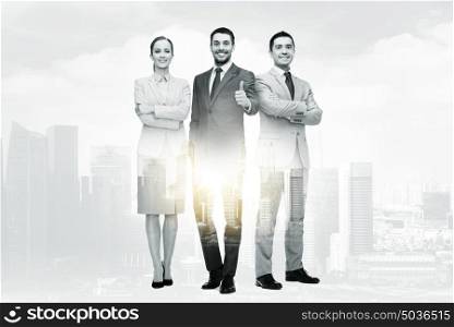 business, gesture and people concept - group of smiling businessmen showing thumbs up over city buildings and double exposure effect. group of smiling businessmen showing thumbs up