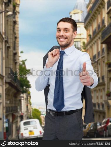 business, gesture and people concept - smiling young and handsome businessman showing thumbs up over old city background