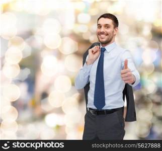 business, gesture and people concept - smiling young and handsome businessman showing thumbs up