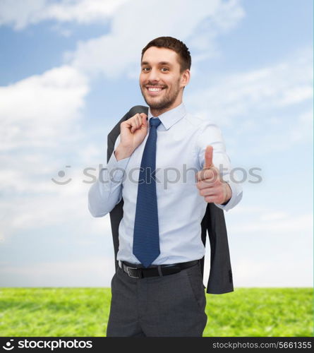 business, gesture and people concept - smiling young and handsome businessman showing thumbs up