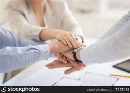 business, gesture and teamwork concept - close up of businesspeople or architects stacking hands. close up of business team stacking hands
