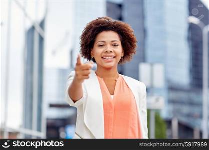business, gesture, hiring and people concept - young smiling african american businesswoman pointing finger on you in city