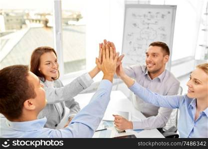 business, gesture, people and teamwork concept - happy creative team making high five at office. happy business team making high five at office